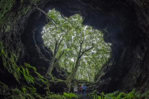 A group of people exploring “gruta das torres” on Pico Island at the Azores 